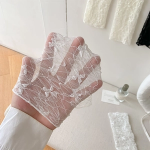 Detail of white lace fabric with floral patterns and breathable mesh texture