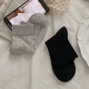 Detail view of ballet-style mesh socks with lace patterns and ribbed cotton textures