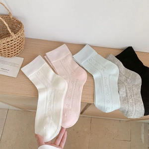 Detail showing five colors of heart-shaped hollow mesh knit socks in sweet ballet style