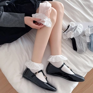 Close-up of white lace ruffle socks for women in various colors on cozy home background