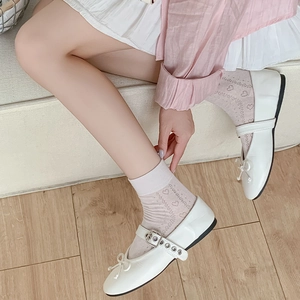 Close-up of white Mary Jane shoes with heart pattern lace socks in sweet Japanese style