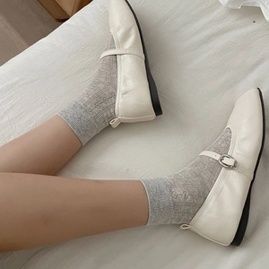 Ballet style white mesh socks with bow tie detail worn with Mary Jane shoes