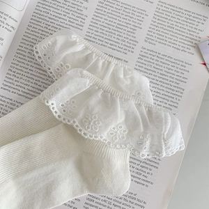 Detailed close-up of delicate double-layered white lace trim on cotton knit socks
