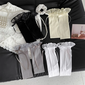 Flat lay of Japanese style over-the-knee socks with lace ruffles and ribbon bows