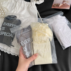 Detail of four pairs of lace socks in black, grey, and white with elegant zip packaging