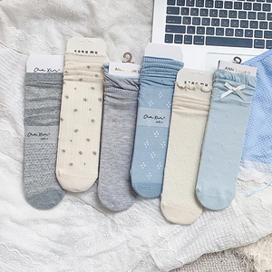 Close-up of 6 pairs of blue and grey floral lace hollow socks with bow details