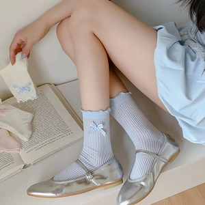Pastel ruffled socks with bow detail and vertical knit pattern in blue white and pink