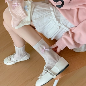 Sweet women's rib-knit crew socks with side ribbon bows in pink and white tones