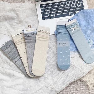 Five pairs of Japanese-style hollow flower socks in blue, grey, and white with bows