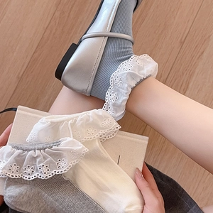 Detailed view of delicate embroidered lace edges on gray and white ankle socks