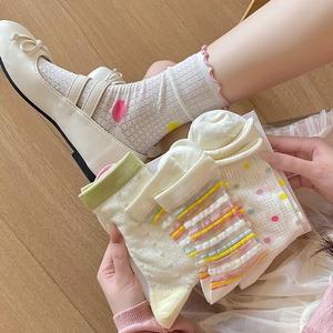 Detail view of breathable hollow heart socks with cute ruffle trim and colorful dots