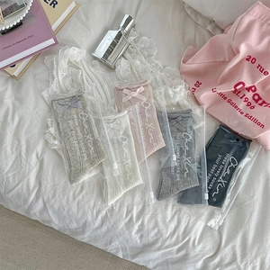 Detail of sweet bow socks with hollow mesh patterns in individual zipper bags