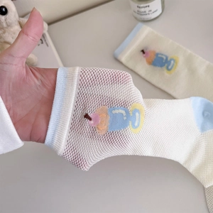 Detail of breathable mesh crew socks with cute cartoon ice cream pattern and blue trim