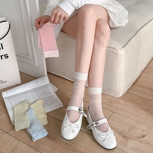 Detailed view of mesh socks with heart patterns in white, pink, yellow, blue, and green