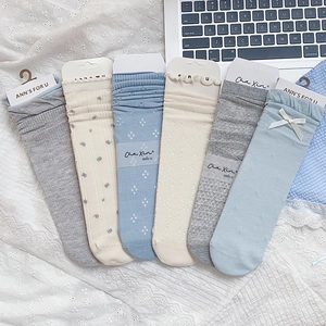 Detail of 6-pack blue and grey floral socks with lace edges and ribbon bows