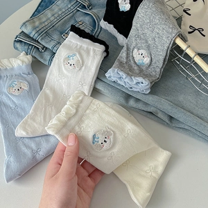 Detail of ruffled cuffs and cute puppy embroidery on cotton knit crew socks