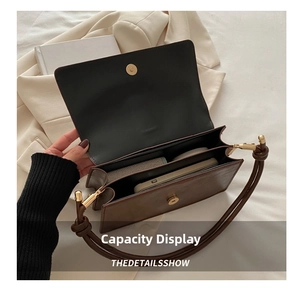Detailed interior of vintage brown leather handbag showing phone and wallet storage