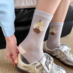 Detail of grey-purple mid-calf socks featuring creative cupcake embroidery and soft cotton texture