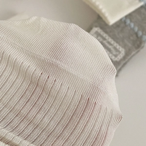 Detail view of white lace socks featuring a ribbed knit texture and breathable mesh design