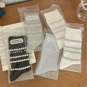 Detail of five-pair ruffle socks in multiple colors with textured wave pattern packaging