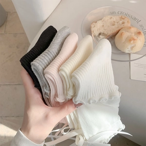 Detailed set of five ribbon bow ballet socks with mesh texture and ruffled edge trim