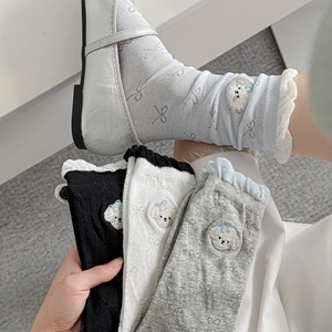 Detail of cute puppy embroidery and scalloped lace trim on sweet style crew socks