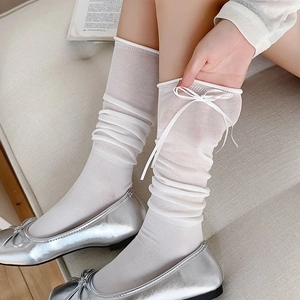 White sheer mid-calf socks with silk ribbon bow and slouchy texture for a sweet look
