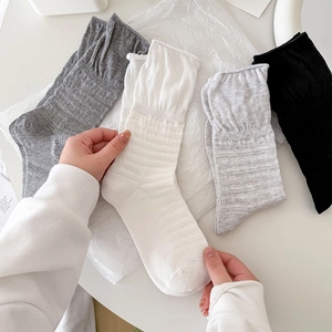 Set of four mesh ruffled mid-calf socks in black, white, and grey with vertical rib texture