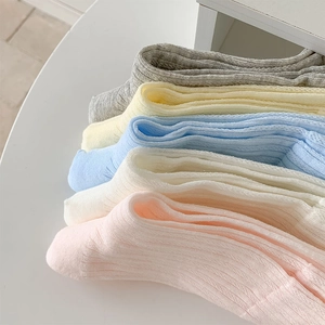Close-up of colorful ribbed cotton socks in soft pastel pink blue and yellow shades