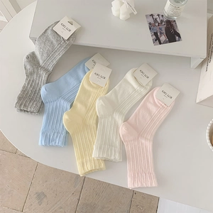 Detailed view of pastel striped crew socks in a fan-shaped colorful five-pair collection
