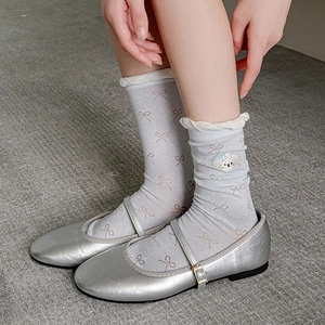 Silver Mary Jane shoes paired with gray lace-edge socks featuring puppy embroidery