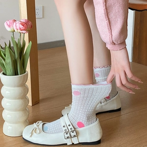 Detail of white mesh socks with colorful polka dots paired with bow Mary Jane shoes