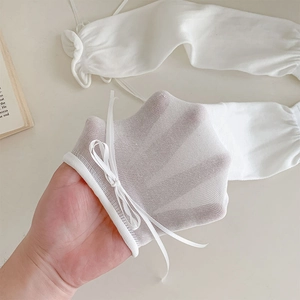 Close-up of white sheer mesh leg warmers with delicate ribbon bows in sweet JK style