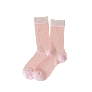 Sweet pink mesh crew socks with heart patterns and sheer lace texture on white background