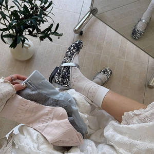 Detail of hollow floral knit socks in soft pastel colors with vintage aesthetic