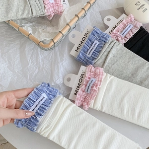 Detail view of cotton crew socks featuring plaid lace trim and Mimor Studio woven label