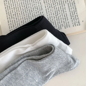 Detail of sweet JK style ribbed knit socks in black, white and grey with soft texture