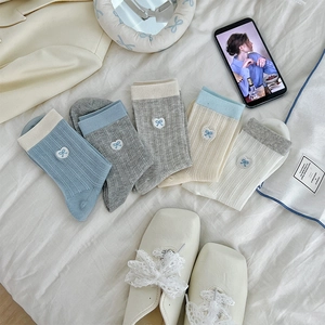 Detailed view of breathable mesh cotton socks with elegant blue bow embroidery details