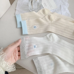 Detailed knit texture and heart embroidery on breathable hollow mesh crew socks