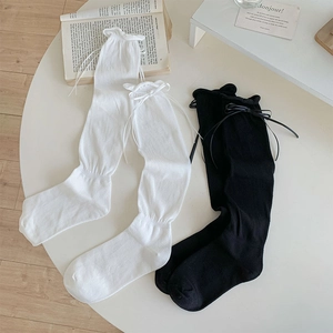 Detail of ruffled cuffs and ribbon bows on sweet JK style over-the-knee socks