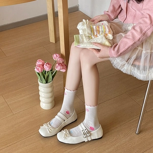 Breathable mesh women's crew socks with pink polka dots and elegant ruffled cuffs