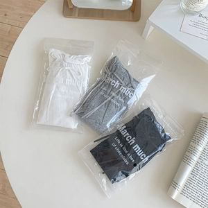 Three pairs of sweet bowknot socks in white, grey, and black individual packaging