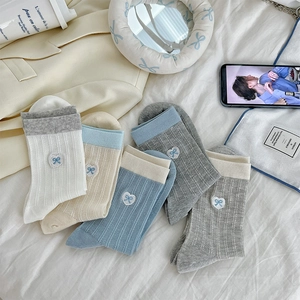 Detail of five pairs of bow embroidered mesh socks in assorted soft pastel colors