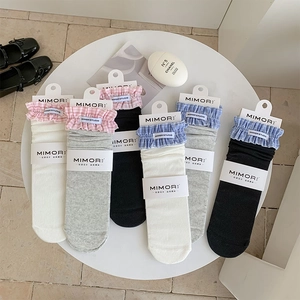 Detailed view of cotton mid-calf socks with plaid ruffle lace trim in various soft colors