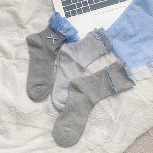 Three pairs of sweet bow mid-calf socks with lace edges and ribbed cotton texture for women