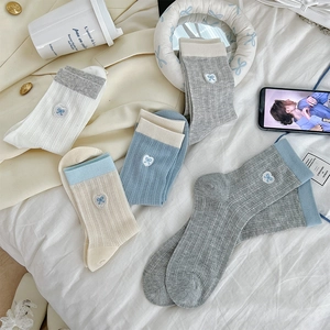 Detail of heart and bow embroidery on ribbed cotton crew socks in pastel colors