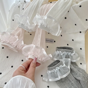 Detail of sweet Lolita-style mesh socks with multi-layer organza lace and ribbon trim