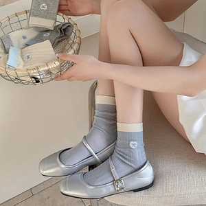 Detail of sweet heart embroidery on soft ribbed cotton socks with Mary Jane shoes