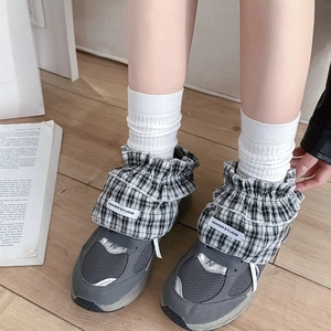 Grey mesh sneakers with ballet style plaid ruffle leg warmers and bow details