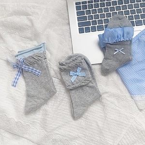 Three pairs of sweet grey cotton socks with blue plaid bows and ruffled edge trim